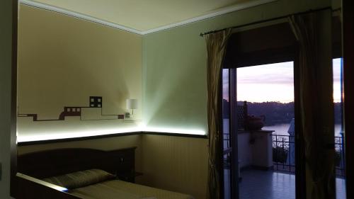 a bedroom with a bed and a view of a balcony at Hotel Villa Degli Angeli in Castel Gandolfo