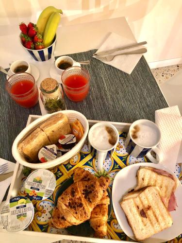 a tray of food with bread and other foods on a table at Favola Guesthouse Affittacamere in Nettuno