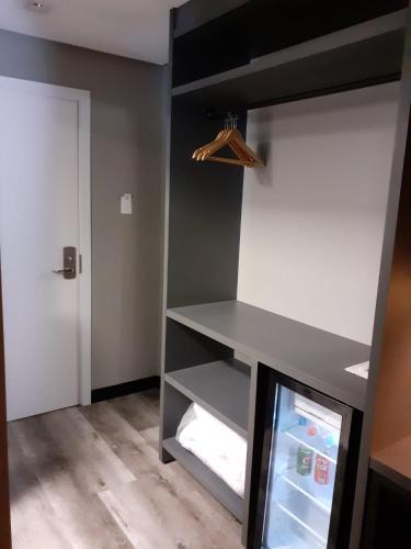 a kitchen with a refrigerator and a door at Hotel Le Canard Lages in Lages