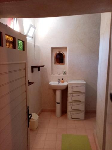 a white bathroom with a sink and a toilet at Douar amazza in Taroudant