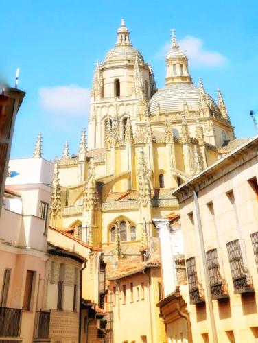 a large building with a tower on top of it at Hostal Juan Bravo in Segovia