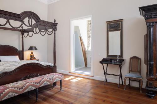 a bedroom with a bed and a table with a mirror at Jagdschloss Kotelow in Kotelow