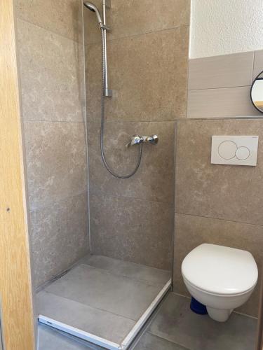 a bathroom with a shower and a toilet at Era Home 2 in Murg