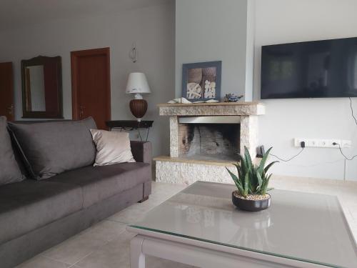 a living room with a couch and a fireplace at Villa Marilena in Nafpaktos