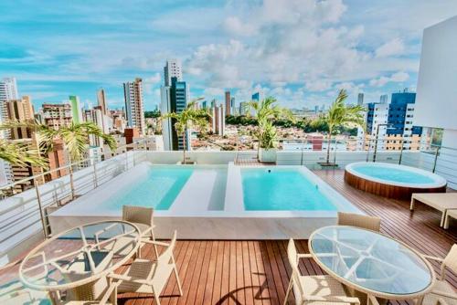 a balcony with a swimming pool on top of a building at PHGFlats Manaira apart hotel in João Pessoa