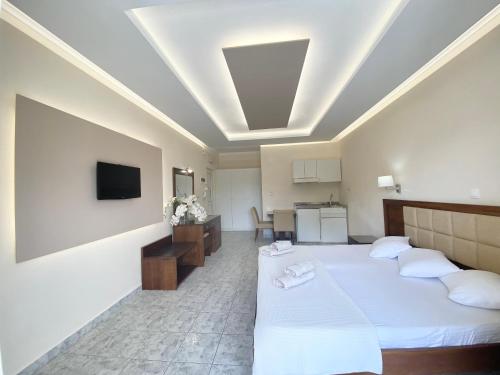 a hotel room with two beds and a kitchen at Hotel Sotiris Superior Apartments in Myrina