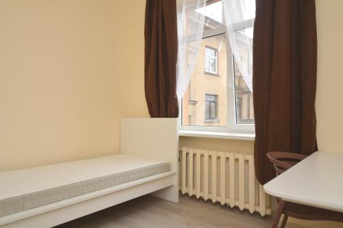 Habitación con ventana, cama y mesa. en Daukanto st 3 Kaunas Students Home LT en Kaunas