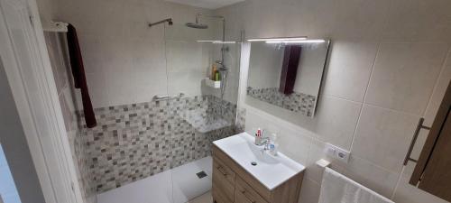 a bathroom with a sink and a shower and a sink at Palmeira in Ribeira