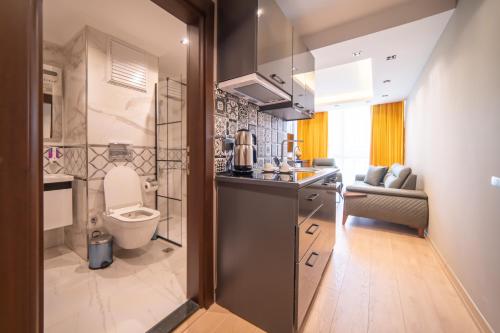 a kitchen with a sink and a toilet in a room at Garden Room Otel in Istanbul