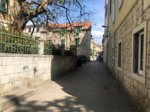 an alley way with a building and a tree at Old Town Lucky Star Split in Split