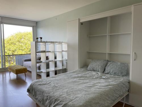 a bedroom with a bed and shelves and a window at Rua das Arcadas do Parque 52 in Estoril