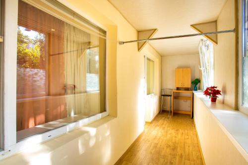 a room with a large window and a kitchen at Sun in the City Center in Kherson