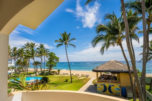 a view of the beach from the balcony of a resort at Agualina Kite Hotel Oceanfront Apartments in Cabarete