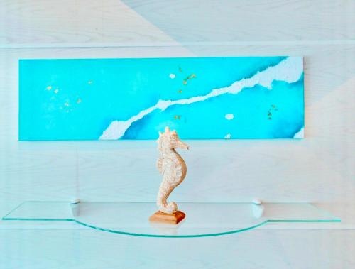 a figurine of a seahorse in front of a painting at Hotel Neptuno in San Pedro del Pinatar