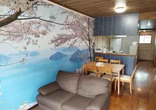 a living room with a couch and a table with a mural at Maison Ota Building A Building B - Vacation STAY 14501 in Takamatsu