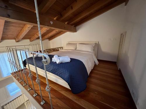 a bedroom with a bed in a room with wooden floors at Cesare Battisti Home in Bologna