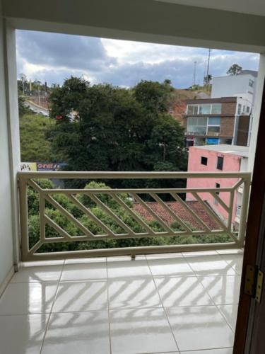 a window of a balcony with a view of a building at Xikus Palace Hotel in Guanhães