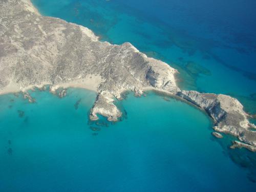 an aerial view of an island in the water at Lithos Traditional Guest Houses in Xerokampos
