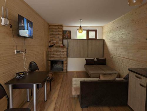 a living room with a couch and a fireplace at DATI in Borjomi