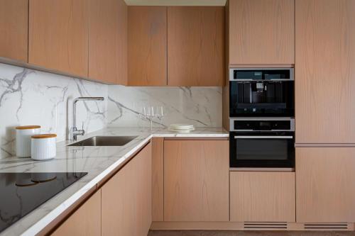 a kitchen with a microwave oven and a sink at The Ritz-Carlton, Baku in Baku