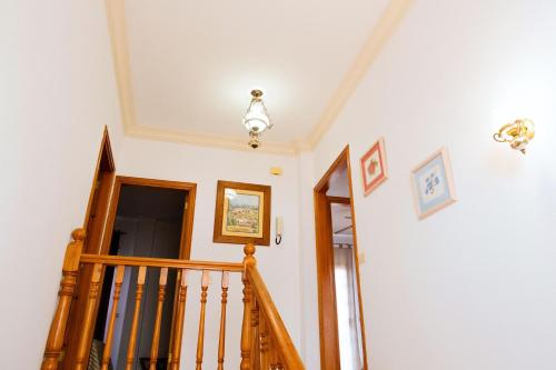 a stairwell with a wooden staircase and a white ceiling at LIVE GUANCHES DE CANDELARIA in Candelaria