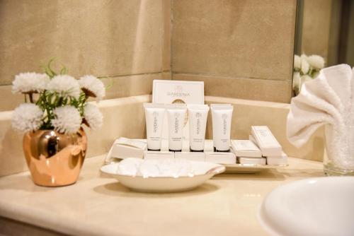 a bathroom counter with a tray of soap and flowers at Grand Plaza Badr Al Maqam in Medina