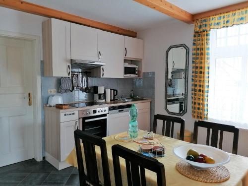 a kitchen with a table with a bowl of fruit on it at Landtraum im Traumland Mecklenburg in Warin