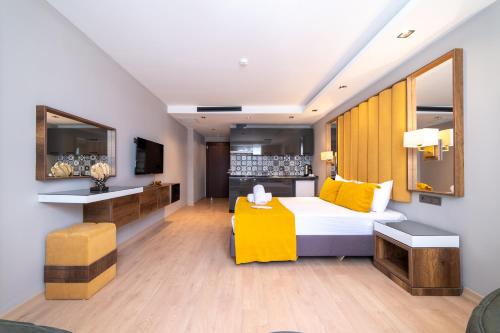 a hotel room with a bed with yellow pillows at Garden Room Otel in Istanbul
