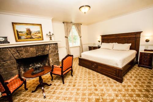 a bedroom with a bed and a fireplace at Vermejo, a Ted Turner Reserve in Raton