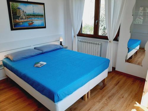 a bedroom with a bed with a blue blanket at Casa Annalisa in Scauri