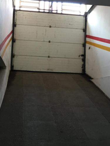 an empty garage with two white garage doors at private room chambre privée in Kenitra
