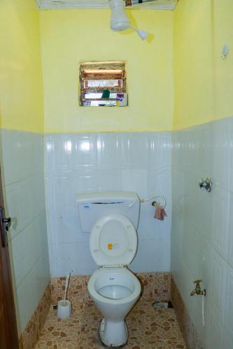 a bathroom with a white toilet in a room at Trendy Homes Studio BnB in Bungoma