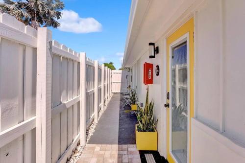 a hallway of a house with a yellow door and plants at Laguna @ Casa Del Sol in Fort Lauderdale