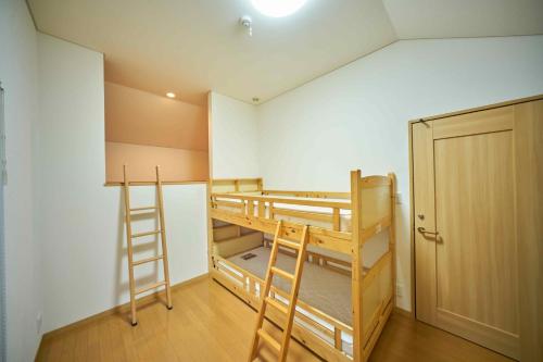 a room with two bunk beds and a closet at Guest House Kingyo - Vacation STAY 14498 in Sapporo
