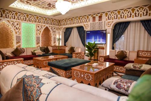 a living room with couches and tables at Grand Plaza Badr Al Maqam in Medina