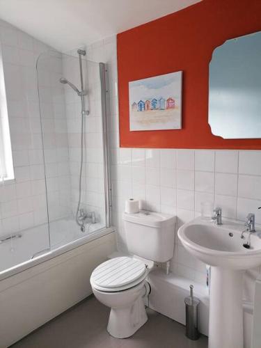 a bathroom with a white toilet and a sink at Miller's Cottage in Lancaster in Lancaster