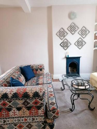 a living room with a couch and a fireplace at Miller's Cottage in Lancaster in Lancaster