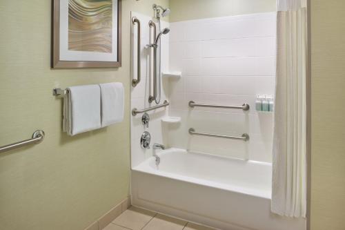 a bathroom with a tub and a shower with towels at Courtyard by Marriott Nashville Goodlettsville in Goodlettsville