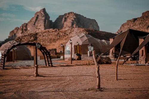 a desert area with a tent and some rocks at Rum city Star LUXURY Camp in Wadi Rum