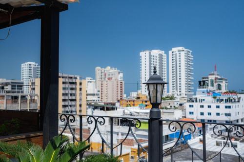 a view of a city from a balcony with a street light at Hotel Boutique ADAZ in Santa Marta