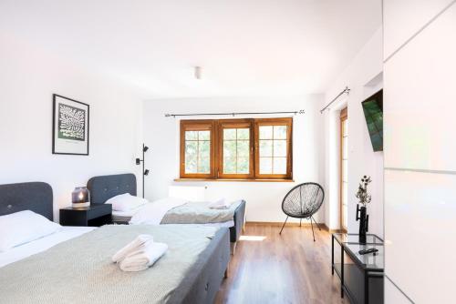 a bedroom with three beds and a window at Bahia Rogowo in Rogowo