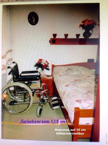 a room with a wheelchair next to a bed at Christa & Wilfried Lammermann in Hooksiel
