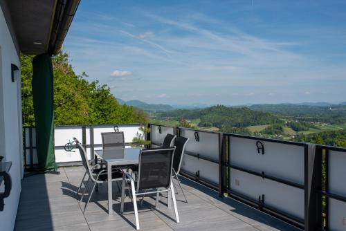 a patio with a table and chairs on a balcony at Apartmaji Gračner in Dramlje