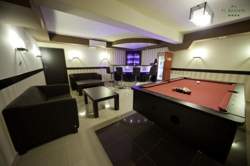 a living room with a pool table and a bar at Pensjonat Gaborek in Krynica Zdrój