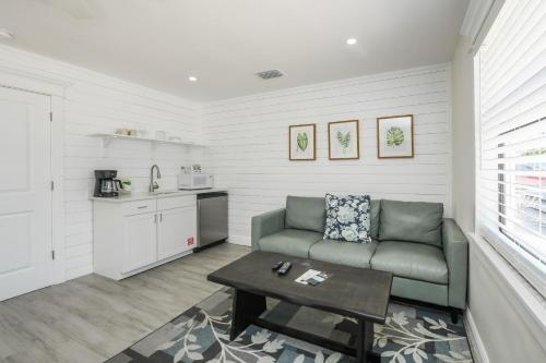 a living room with a couch and a table at The Retreat at Anna Maria Island Inn in Bradenton Beach