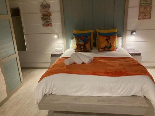 a bedroom with a large bed with two towels on it at Villa Palma in Marbella