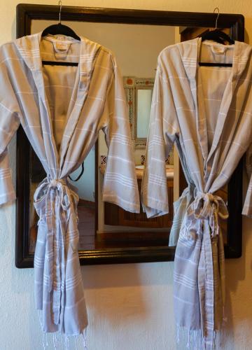 a robe hanging in front of a mirror at Villa Monte in Sayulita