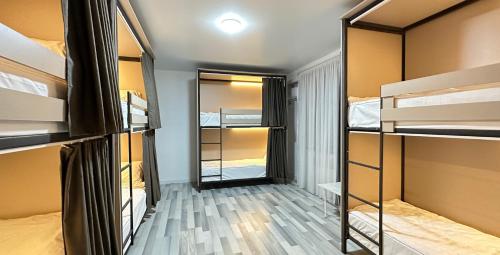 Da! Hostel في بيشكيك: غرفة صغيرة مع سرير بطابقين وممر