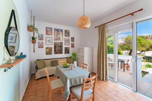 a living room with a table and a couch at Tselios Apartments & Studios in Kiotari