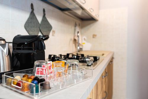 a kitchen counter with glasses and a stove at B&B al Vico Pepe in Castelmezzano